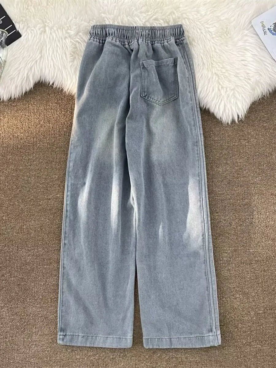 Men's blue wide-leg jeans with drawstring waist and back pocket detail.