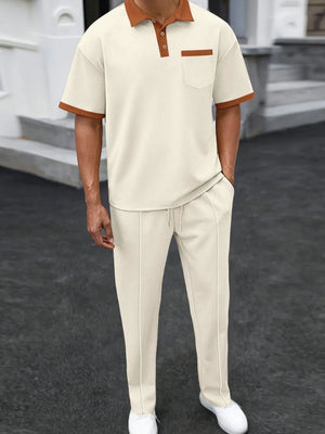 Beige textured polo shirt with contrast collar and pocket, paired with matching track pants.