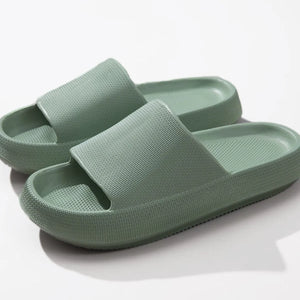 Textured cloud slides slippers in green with a thick, cushioned sole.
