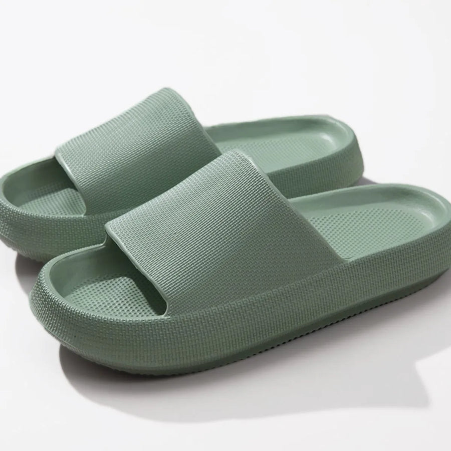 Textured cloud slides slippers in green with a thick, cushioned sole.