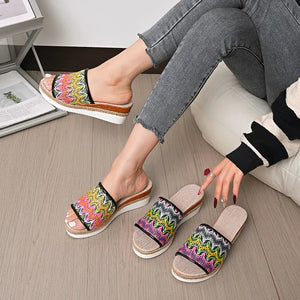 Zigzag embroidered espadrille platform slides with braided jute detail.