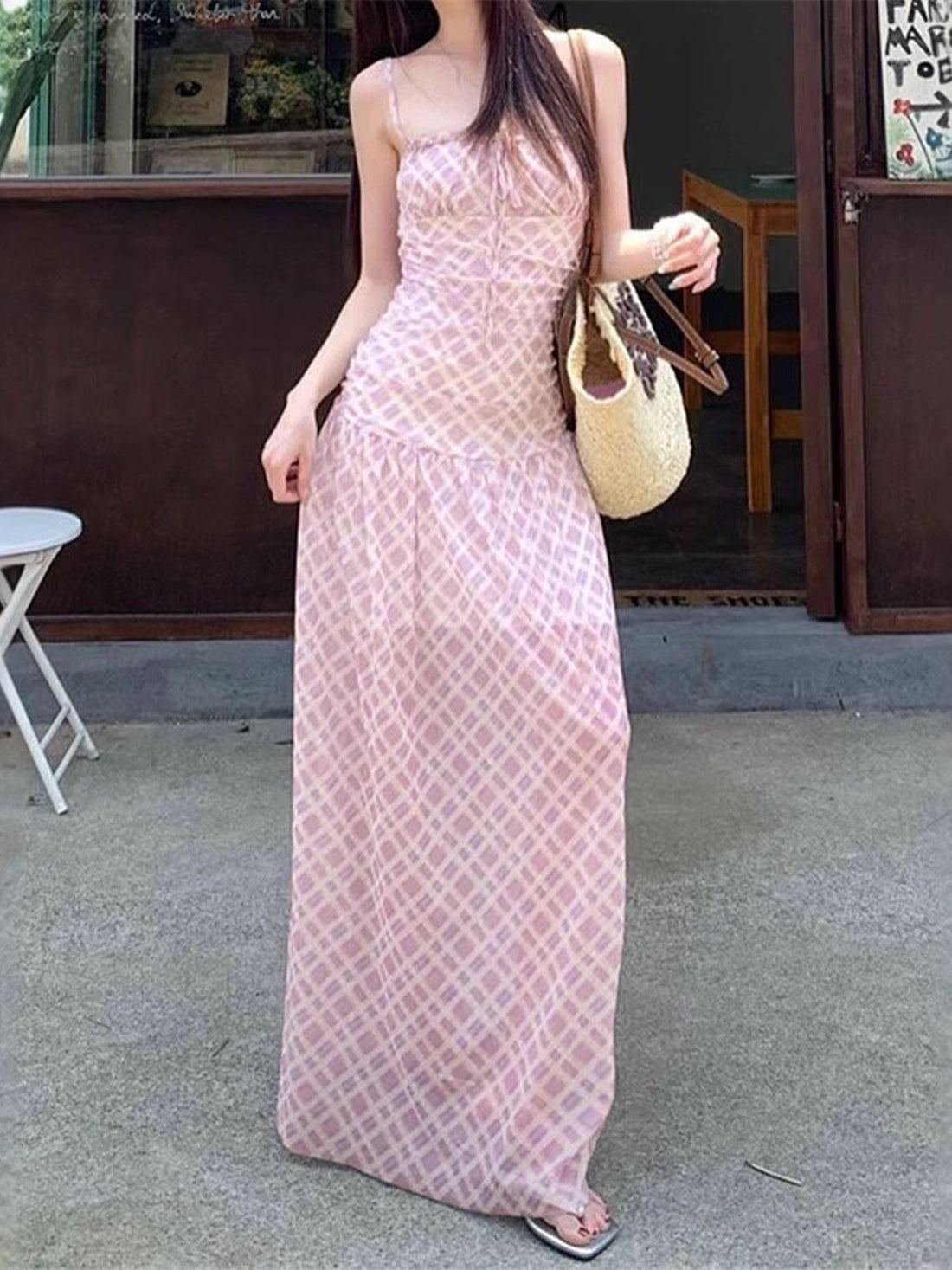 Ruched tied maxi dress in pink plaid with spaghetti straps and a tie front.
