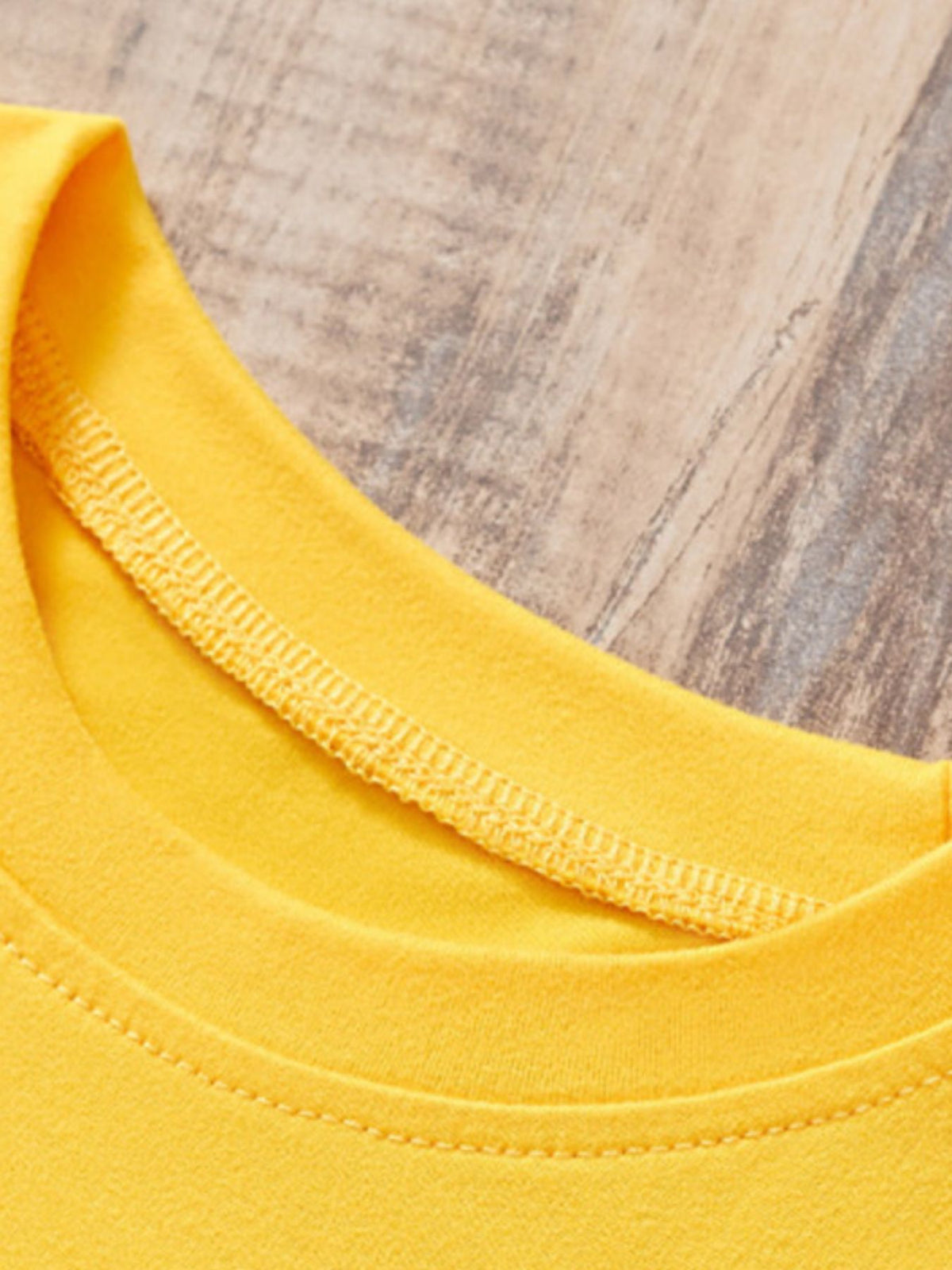 Yellow toddler tee neckline detail with contrast stitching.