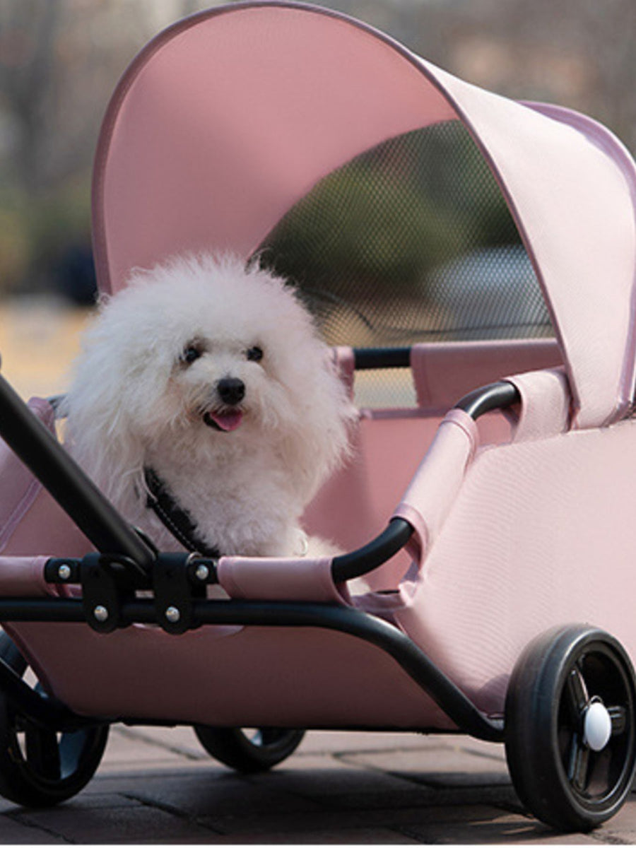 Pink foldable pet stroller with canopy and mesh window, carrying a fluffy white dog.