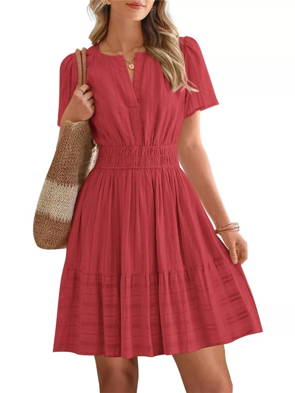 Red textured V-neck tiered dress with smocked waist and short sleeves.