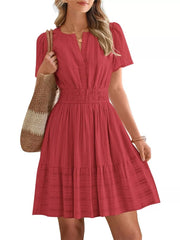 Red textured V-neck tiered dress with smocked waist and short sleeves.