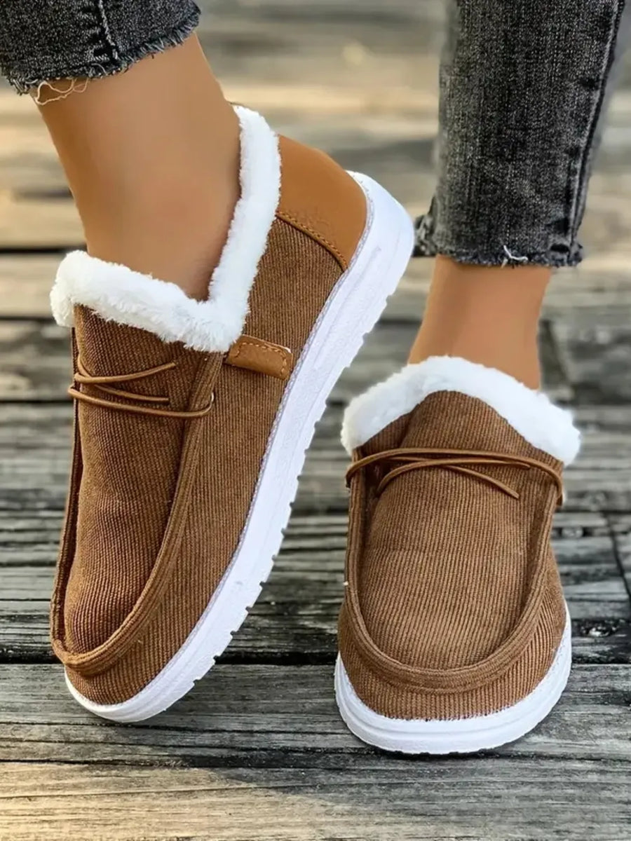 Brown corduroy slip-on sneakers with white sherpa lining and tan accents.