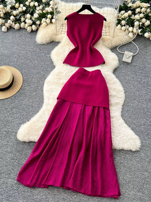 Wine red sheer two-piece set with button details, sleeveless top and pleated skirt.