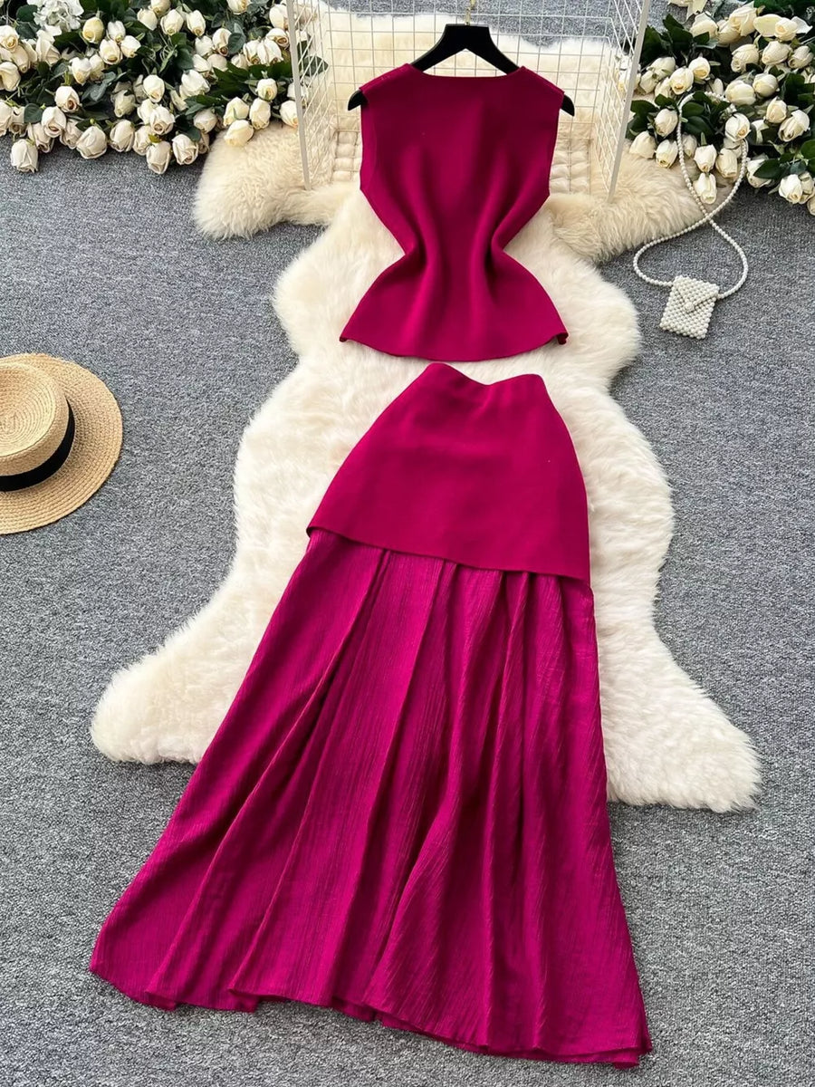 Wine red sheer two-piece set with button details, sleeveless top and pleated skirt.