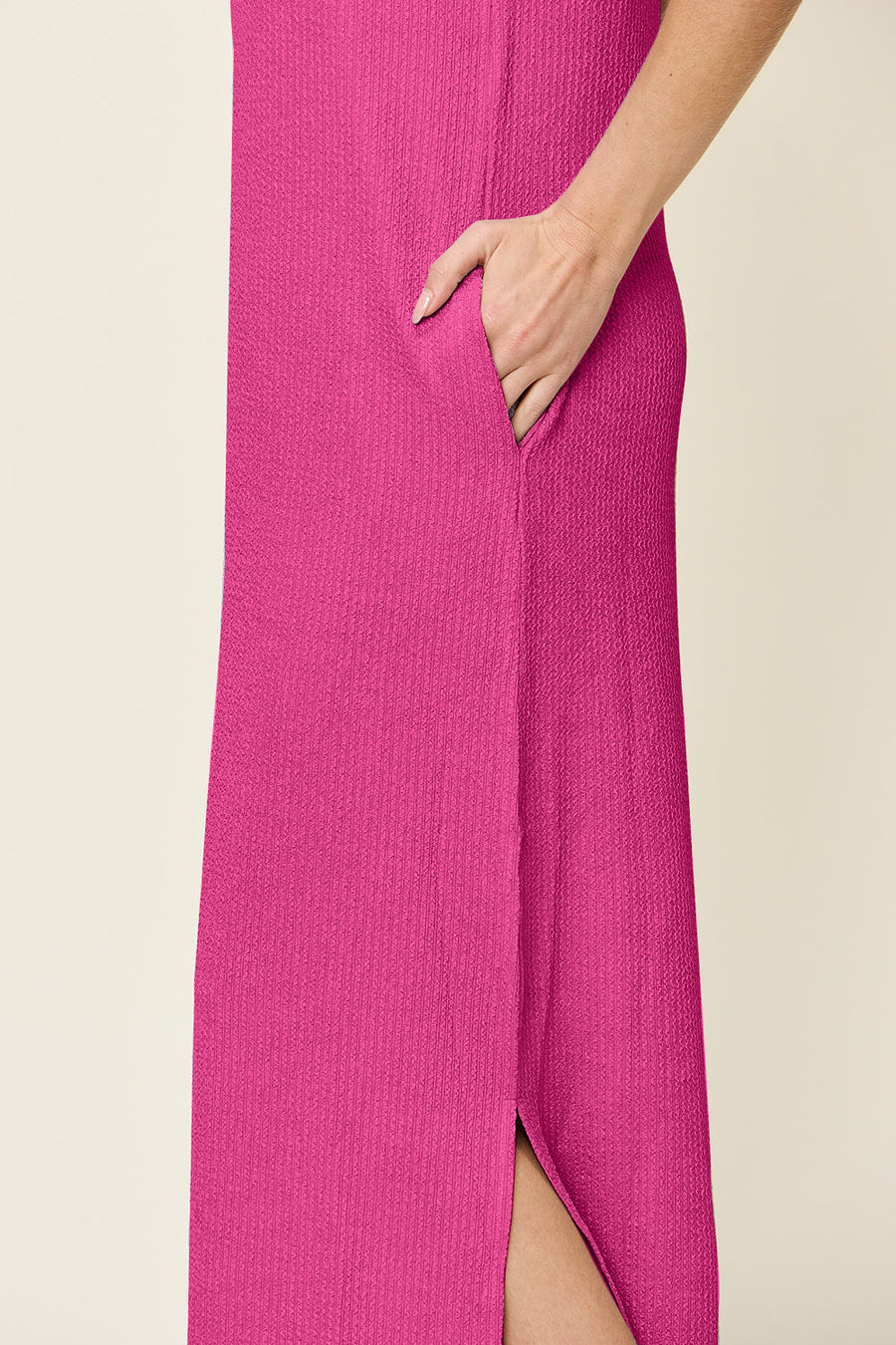 Hot pink ribbed maxi dress with side slits and pockets.