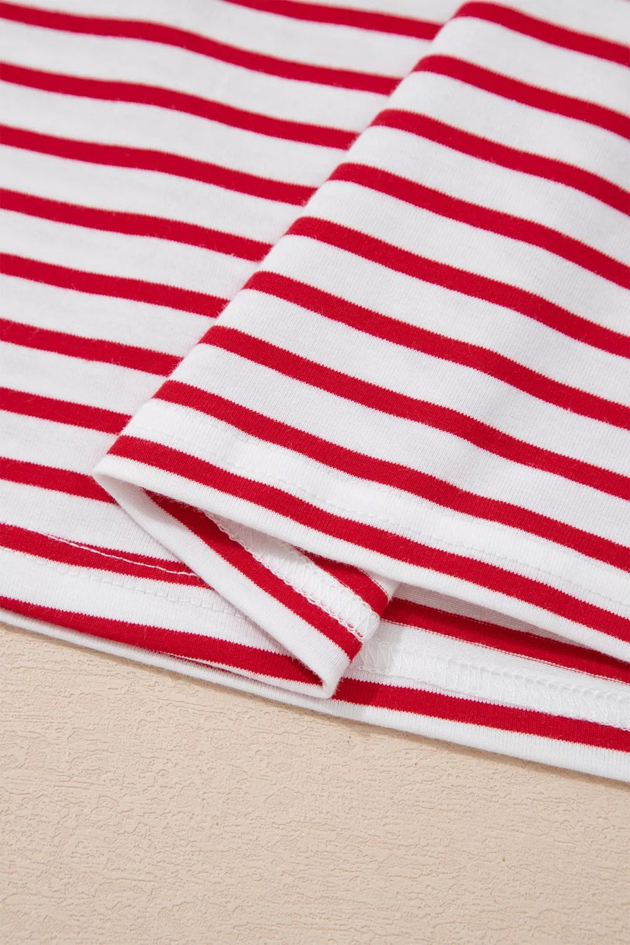 Maternity shirt with red and white stripes, cotton fabric, puff sleeve detail visible.