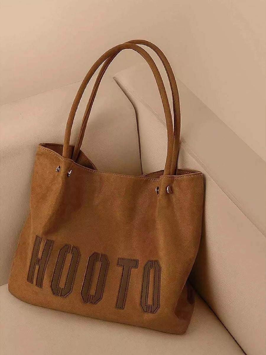 Brown PU leather tote bag with HOOTO lettering and double straps.