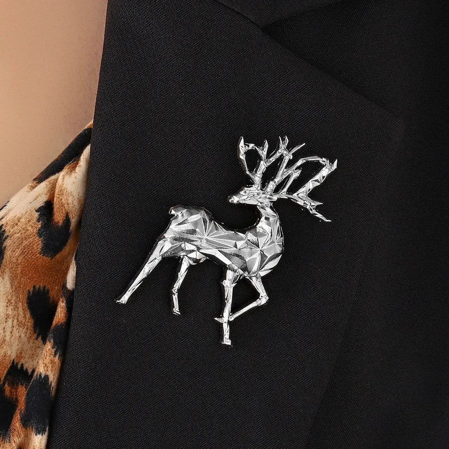 Silver geometric stag brooch lapel pin on black jacket with leopard print detail.