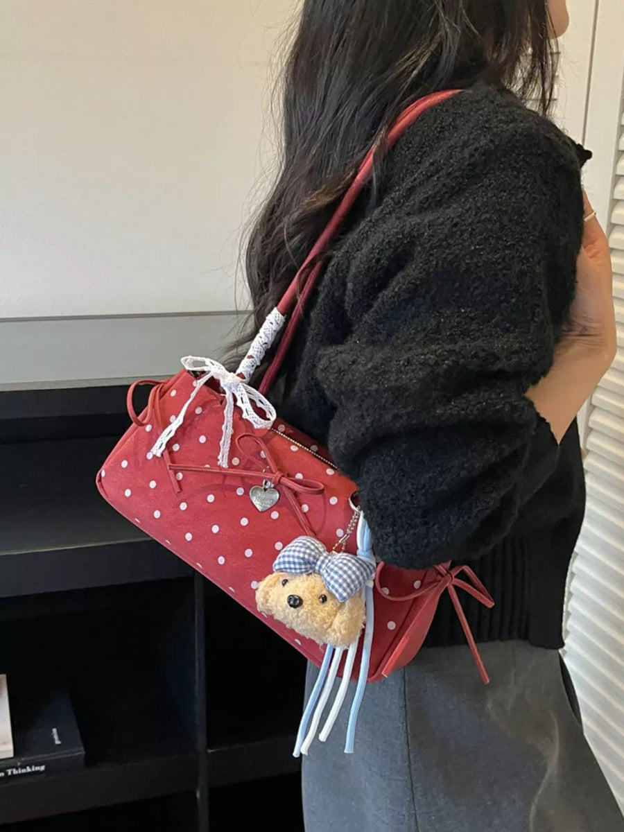 white shoulder bag featuring polka dots and polka-dot