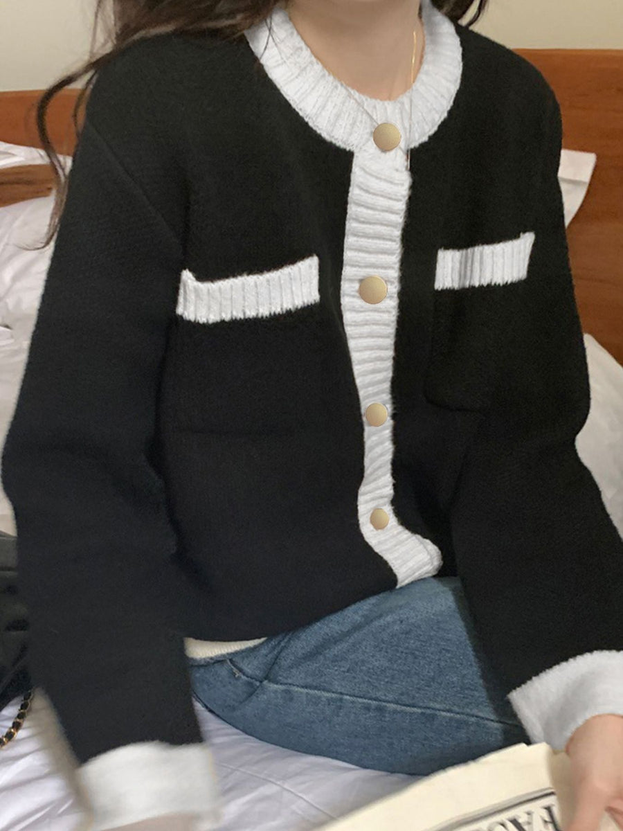 Black acrylic button up cardigan with white contrast trim and gold buttons