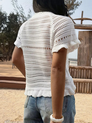 White knit top with openwork pattern, ruffled hem, and short sleeves.