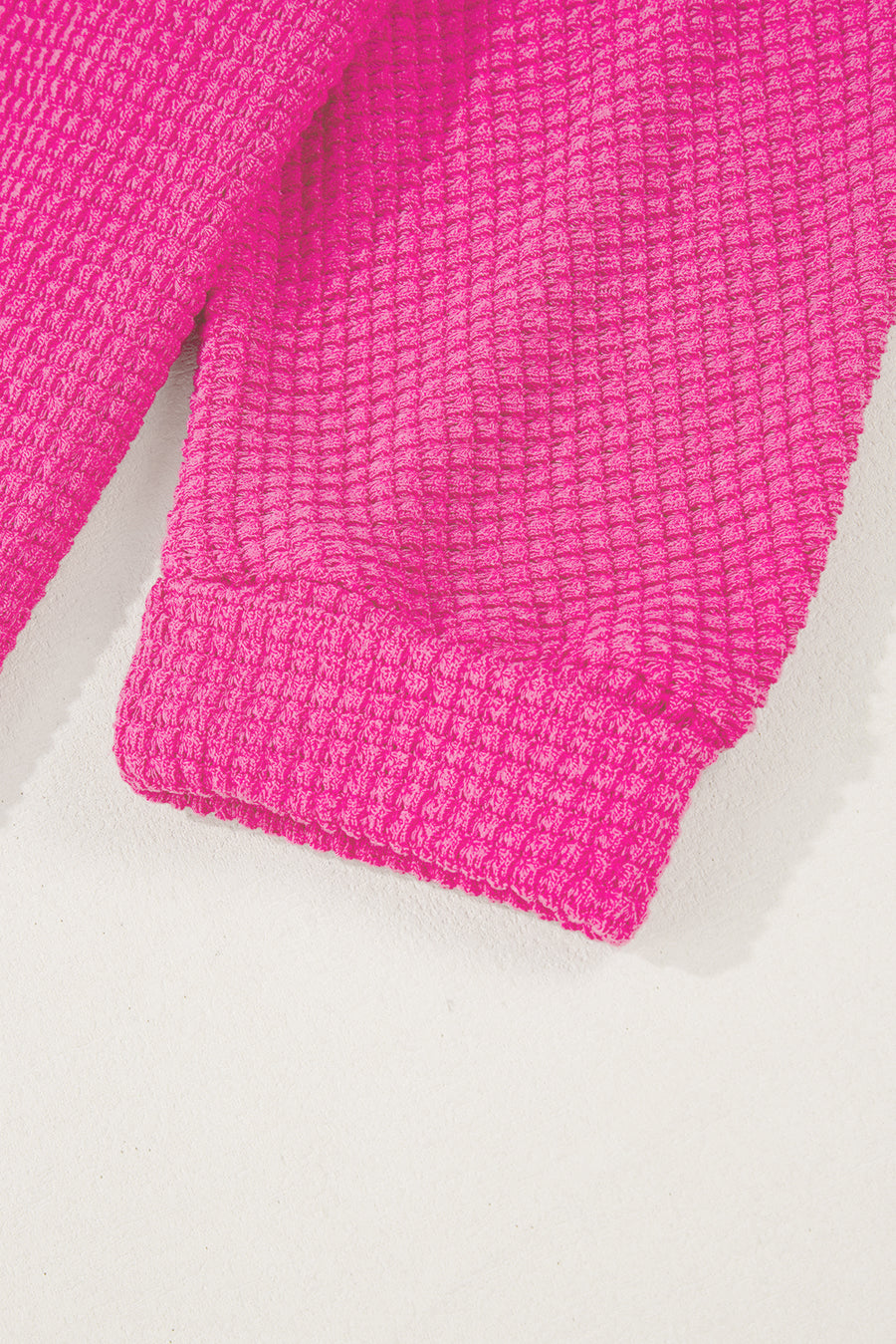 Hot Pink waffle knit sweater with ribbed cuffs and hem detail.