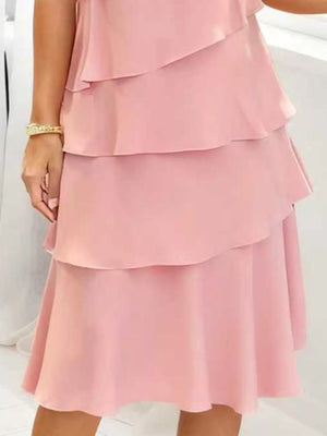 Blush pink tiered ruffle dress with petal sleeves and a feminine fit.