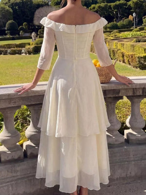 Elegant cream off-shoulder midi dress with ruffled neckline and tiered skirt