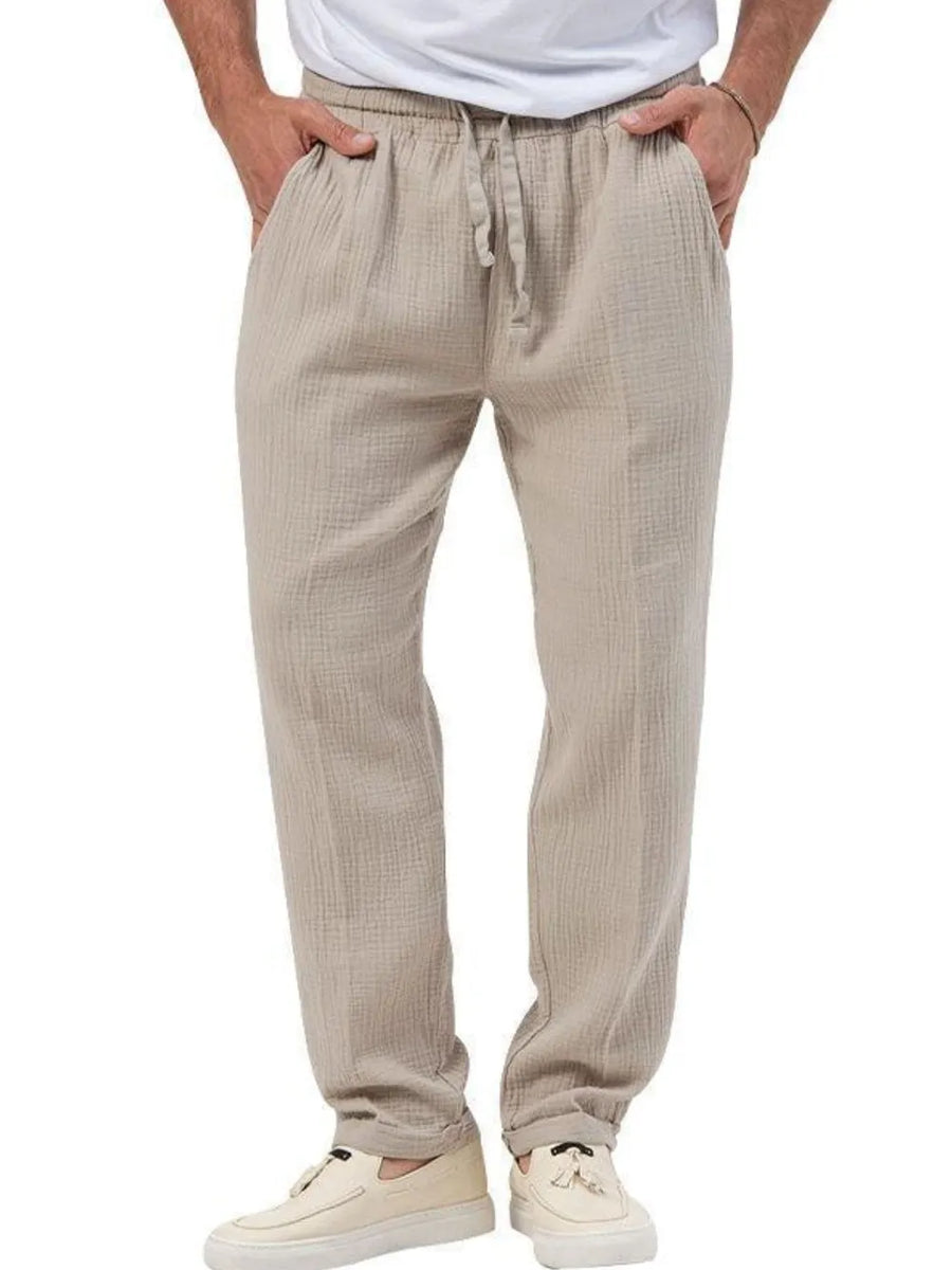 Textured taupe linen blend trousers with drawstring waist and pockets.