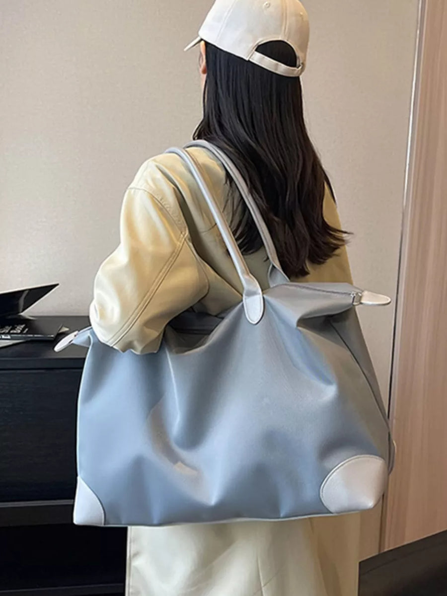 Grey Oxford cloth travel tote bag with white trim and handles.