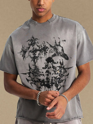Gray distressed graphic tee with raw hem and gothic print.