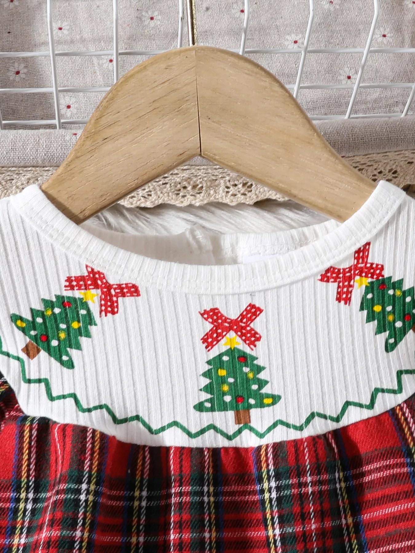Baby girl's long-sleeve dress with Christmas trees and red plaid skirt.