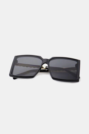 Black geometric sunglasses with gradient lenses and a bold square frame.