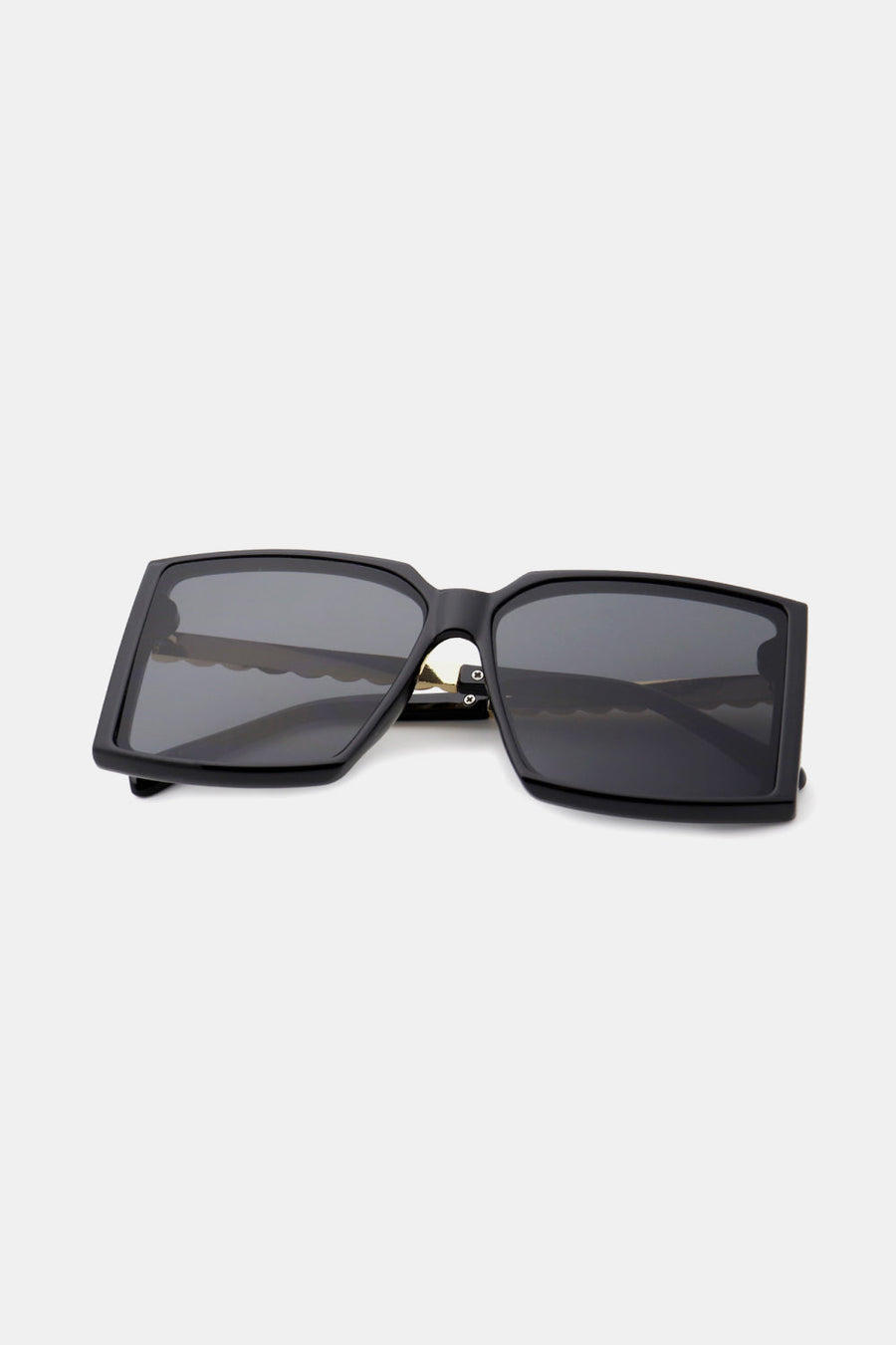 Black geometric sunglasses with gradient lenses and a bold square frame.