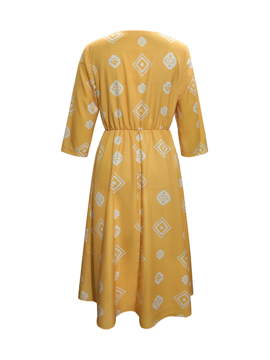 Yellow geometric print empire waist midi dress with 3/4 sleeves.