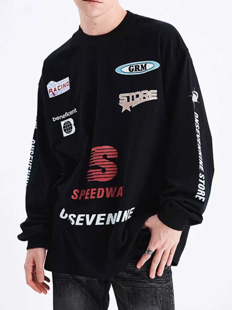 Black long sleeve t-shirt with multiple graphic patches and text details.