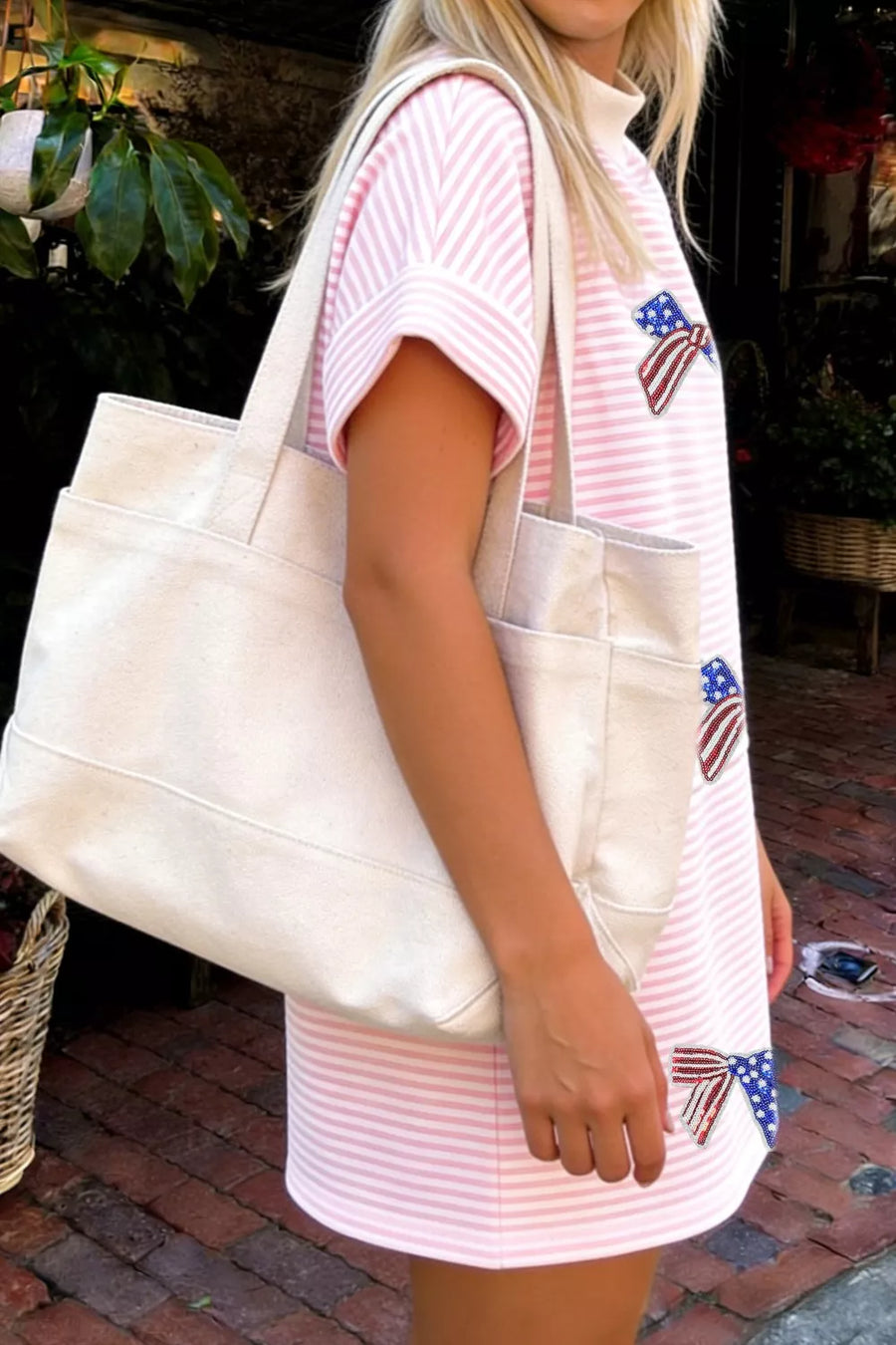 Pink striped mini dress with American flag bows, short sleeves, and mock neck.
