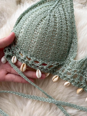 Green crochet halter bikini top with shell trim and tie straps.