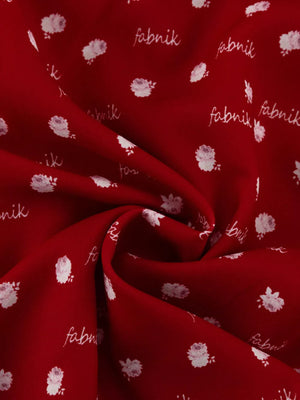 Red fabric with white floral print and "fabnik" text pattern