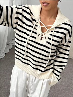 Black and white striped long-sleeve sweater with lace-up neckline detail.