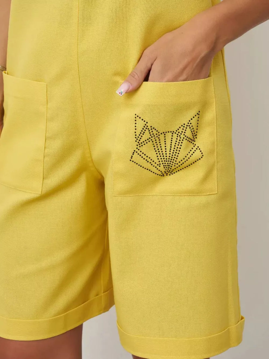 Yellow cotton romper with tie straps and a pocket featuring a black fox design.