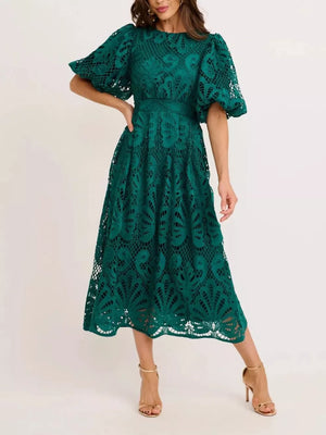Green lace midi dress with puff sleeves and a round neckline.