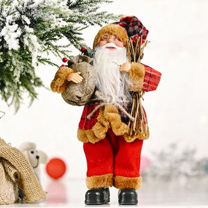 Festive tartan Santa figurine in red with fur trim, holding a gift sack and bundle of sticks.