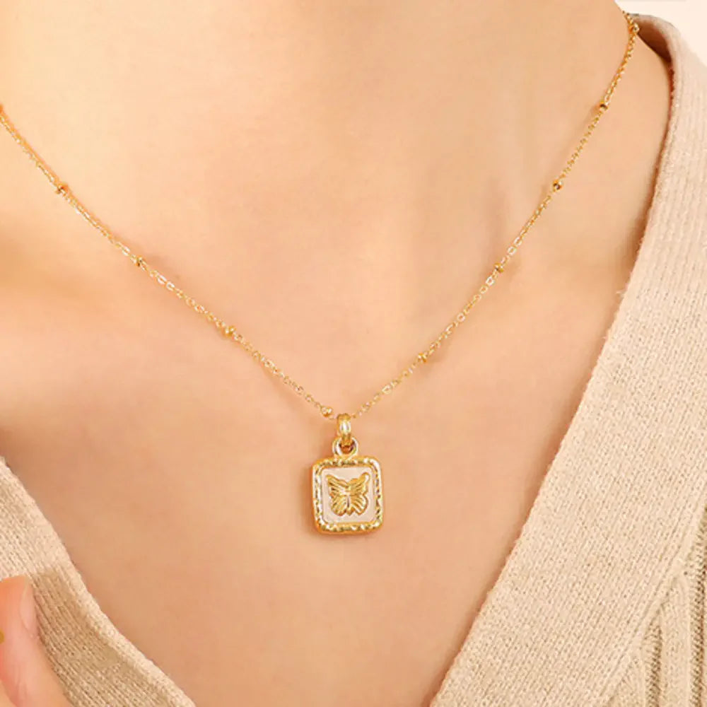 Gold butterfly inlay square pendant necklace with adjustable chain.