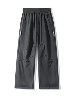 Men's gray loose fit cargo pants with drawstring and zip pockets.