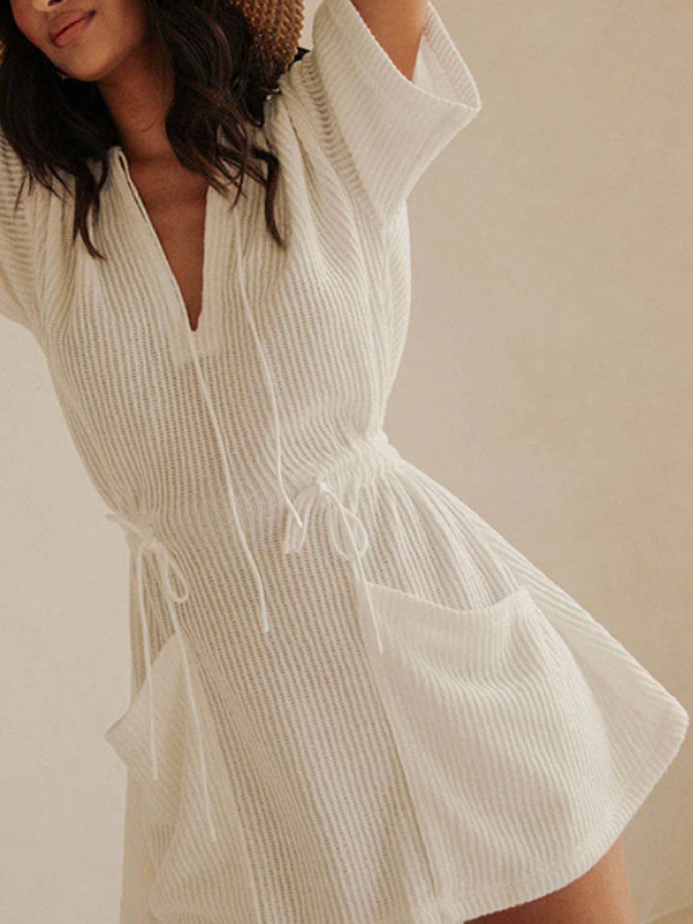 White textured half sleeve cover-up dress with drawstring waist and pockets.