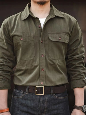 Army green cotton twill utility shirt with two chest pockets and button front.