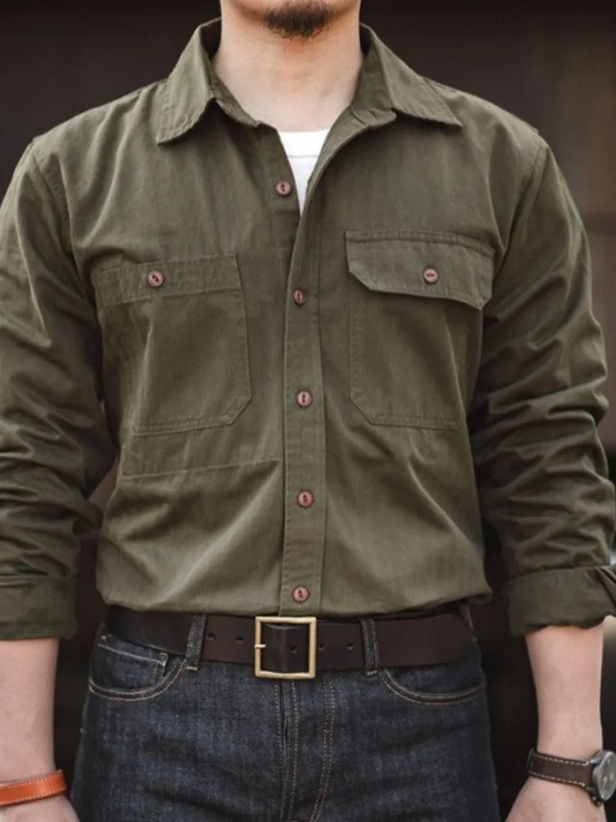 Army green cotton twill utility shirt with two chest pockets and button front.