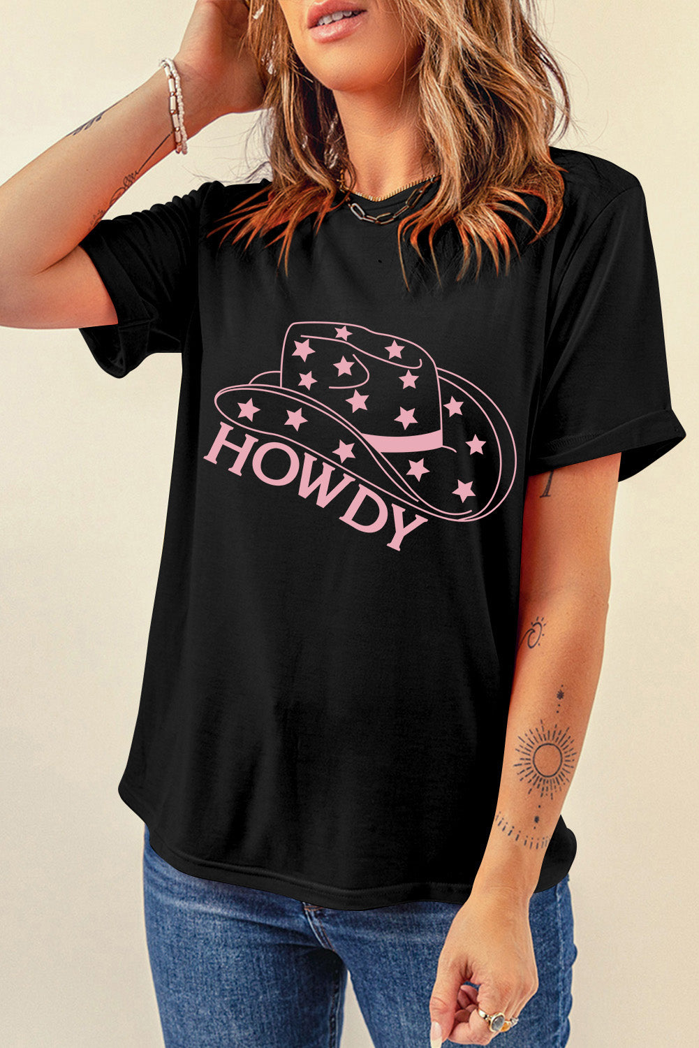 Black cotton graphic tee with rolled sleeves and a pink Howdy cowboy hat with stars design.