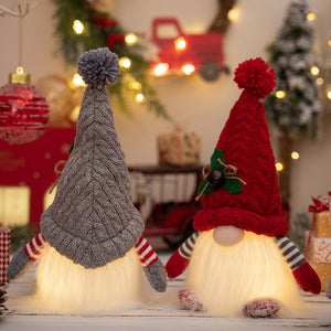 Illuminated knit gnomes in deep red and light gray with pompom hats and striped arms.