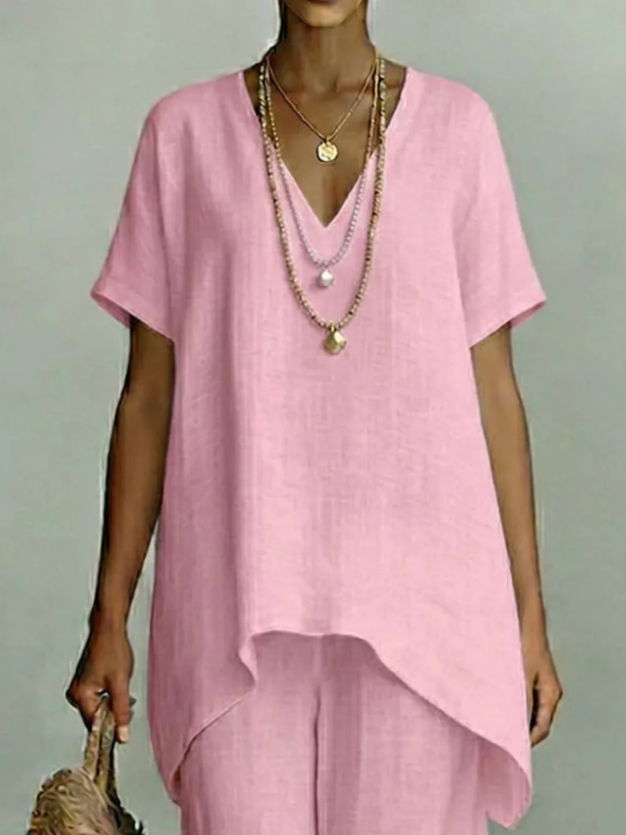 Pink linen v-neck short sleeve tunic top with layered necklaces and matching pants.