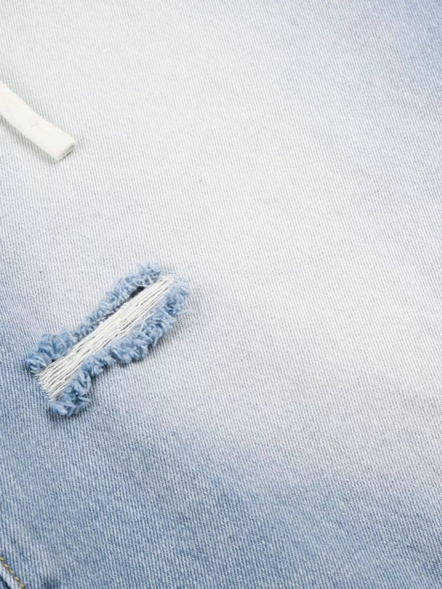 Men's distressed wide-leg capri jeans in light blue denim with frayed details.