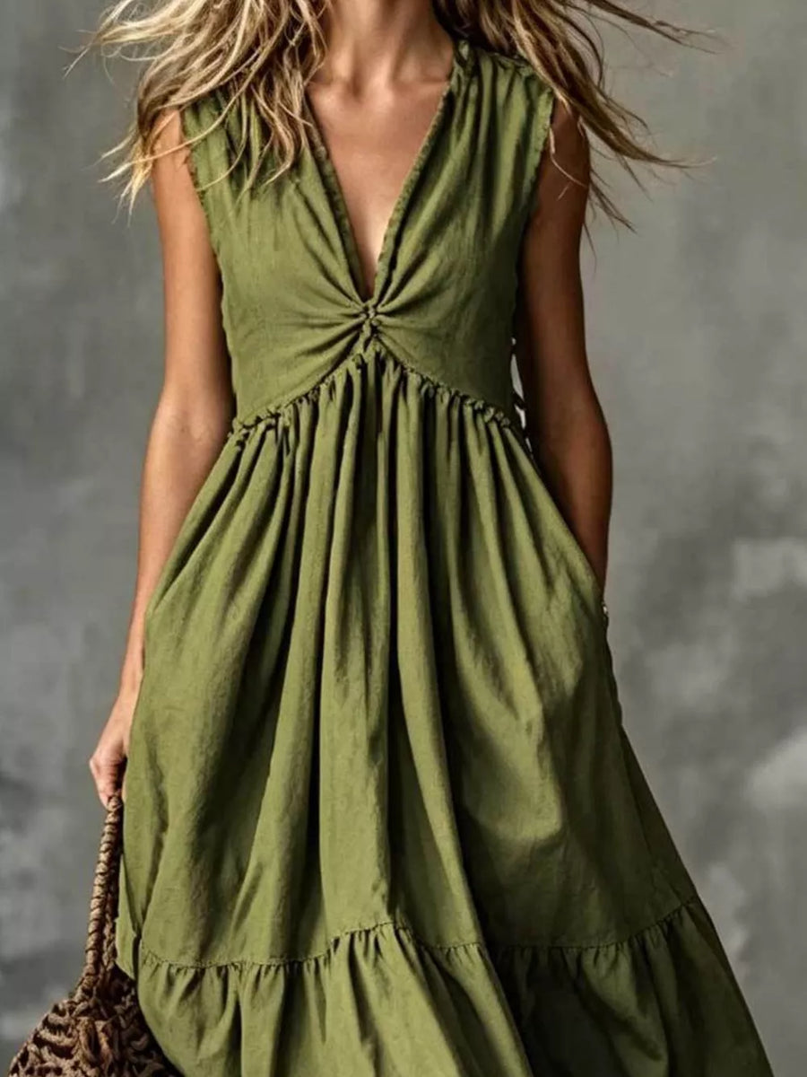 Olive green linen blend dress with deep V-neck, knot detail, tiered skirt, and pockets.