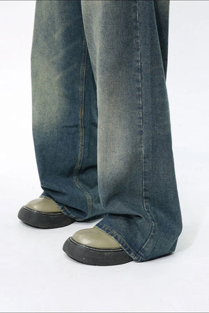 Faded wash wide-leg jeans in medium blue denim with a relaxed fit.