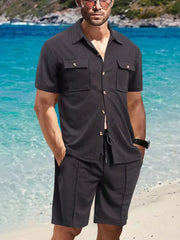 Textured black resort shirt and shorts set with button front and drawstring waist.